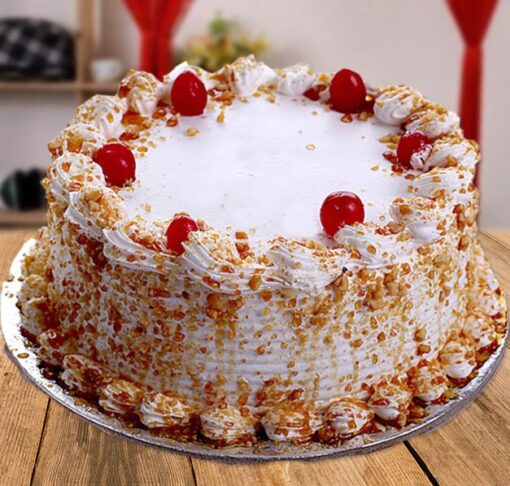 Cherry Flavored Butterscotch Cake featuring a rich butterscotch base with a hint of cherry, topped with cherry pieces and a smooth frosting, perfect for a unique dessert experience.