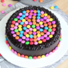 Choco Gems Cake Delight featuring a rich chocolate cake topped with vibrant, colorful choco gems, ideal for adding a sweet touch to any celebration.