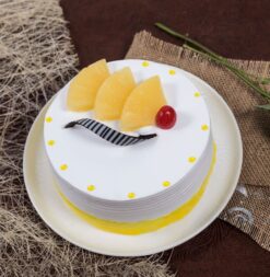 Fruity Pineapple Cake with moist layers infused with pineapple and topped with fresh fruit, ideal for a refreshing and delicious treat.