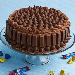 Delicious Kitkat Delight Cake with rich chocolate layers and crunchy KitKat bars, beautifully decorated for a decadent and indulgent dessert experience.