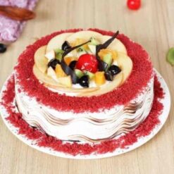 Red Velvet Fruit Cake featuring vibrant red velvet layers and a blend of fresh fruits, topped with creamy frosting for a delicious and eye-catching dessert.