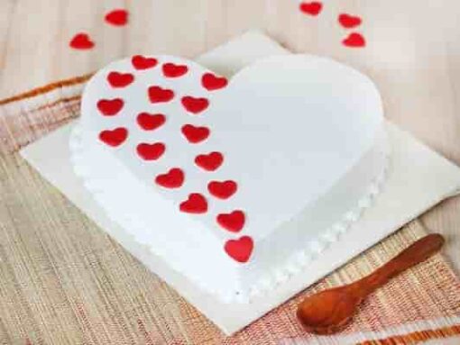 White Heart Vanilla Cake: a beautifully decorated heart-shaped vanilla cake, perfect for weddings, anniversaries, or special celebrations, featuring a smooth white frosting.