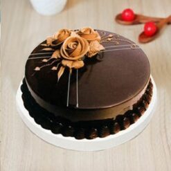 Delicious Rose Chocolate Cake with rich chocolate layers and a hint of rose flavor, garnished with rose petals for a beautiful presentation.