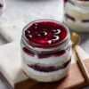 Quad cake jars filled with layers of mixed berries and creamy frosting, perfect for dessert lovers and ideal for gifting.