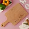 Custom Mom's Kitchen Cutting Board with Handle featuring personalized engraving, perfect for cooking enthusiasts and a thoughtful gift for mothers.