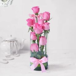 Enchanting Pink Rose Bouquet in a vase featuring lush pink roses with green foliage, arranged elegantly for a beautiful floral display.