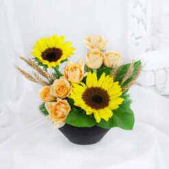 Golden Sunflower Harmony Bouquet featuring a stunning arrangement of bright yellow sunflowers, complemented by green foliage and delicate accents, creating a harmonious and cheerful floral display.