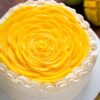 Mango Fruit Cake featuring vibrant mango flavors and a light, fruity texture, ideal for tropical-themed celebrations and special occasions.