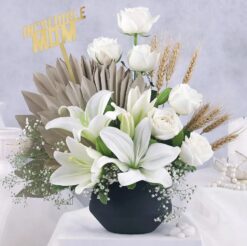 Luxurious bouquet featuring white lilies and roses, arranged to create an opulent and elegant floral display, perfect for special occasions.