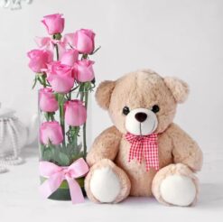 Pink Roses Serenade Vase with Teddy featuring a charming arrangement of pink roses in a vase, complemented by a cute teddy bear for a sweet and thoughtful gift.