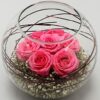 Elegant pink roses in a clear glass vase, showcasing a delicate and romantic floral arrangement ideal for special occasions and home decor.