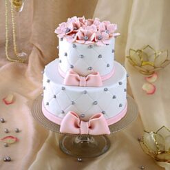 Two-tier designer cake with intricate decorations and elegant layers, ideal for sophisticated celebrations and special occasions