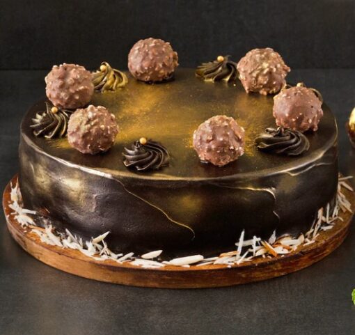 Ferrero Truffle Cake with layers of rich chocolate cake and Ferrero Rocher truffles, perfect for a luxurious and indulgent treat.