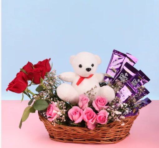 Roses and Teddy Arrangement Basket featuring vibrant red roses arranged with a plush teddy bear, ideal for heartfelt gifts and special occasions.