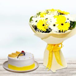 Sunny Gerberas arranged with a pineapple cake, featuring vibrant yellow flowers and a tasty pineapple-flavored cake, ideal for joyful occasions.