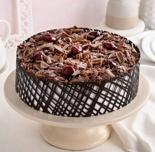 Exotic Layer Black Forest Cake with multiple layers of chocolate sponge, cherries, and creamy frosting, offering a sophisticated dessert experience.