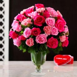 Roses & Carnations in Glass Vase featuring a beautiful mix of roses and carnations arranged in a clear glass vase, ideal for celebrations.