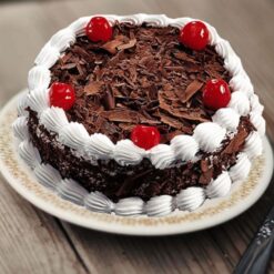 Creamy Black Forest Cake with rich layers of chocolate, cherries, and whipped cream, beautifully decorated and ideal for celebrations and special occasions.