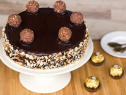 Ferrero Rocher Cake with layers of rich chocolate and crunchy Ferrero Rocher chocolates, perfect for a luxurious and indulgent dessert experience.