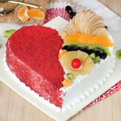 Red Velvet Cake With Fruits, featuring moist red velvet layers adorned with a variety of fresh, vibrant fruits for a delightful and elegant dessert.