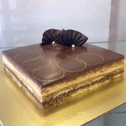 Golden Melody Opera Cake with rich layers of chocolate and coffee cream, elegantly decorated, ideal for special occasions and dessert lovers.