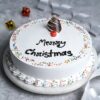 Vanilla Christmas Cheer Cake decorated with holiday-themed designs, featuring a light and fluffy texture, perfect for festive celebrations.