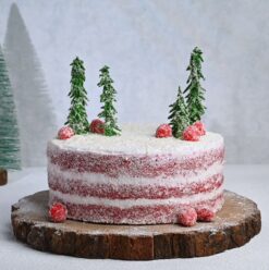 Red Velvet Christmas Charm Cake with rich red velvet layers and festive decorations, ideal for holiday celebrations and Christmas gatherings.