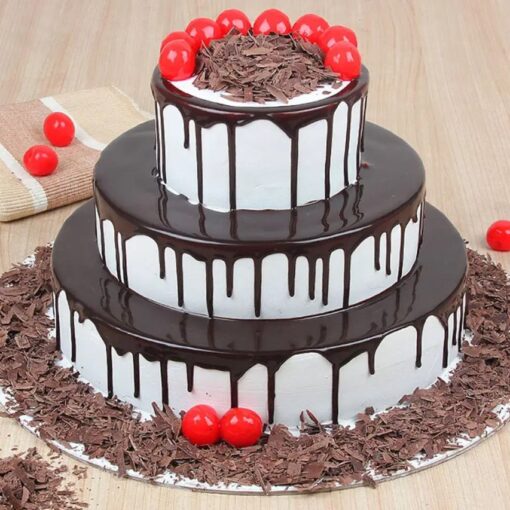 Elegant Black Forest Tier Cake with layers of chocolate sponge, cherries, and whipped cream, adorned for special occasions.