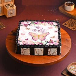 Butterfly Dreams Cake featuring delicate butterfly designs and soft pastel colors, evoking a whimsical and enchanting atmosphere.