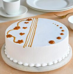 Caramel Kiss Vanilla Cake with creamy vanilla layers and rich caramel drizzle.