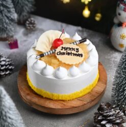 Christmas Pineapple Cake adorned with festive decorations like pineapples, holly, and cheerful holiday accents.