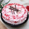 Crimson Delight Cake with vibrant red velvet layers, smooth cream frosting, and exquisite decorative details, perfect for festive occasions.