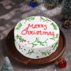 Merry Christmas Cake featuring festive decorations like Christmas trees, holly, and joyful designs, perfect for holiday celebrations.