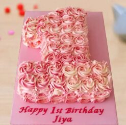 Number one-shaped cake decorated with blooming rose designs in soft hues, ideal for a first birthday or milestone celebration.