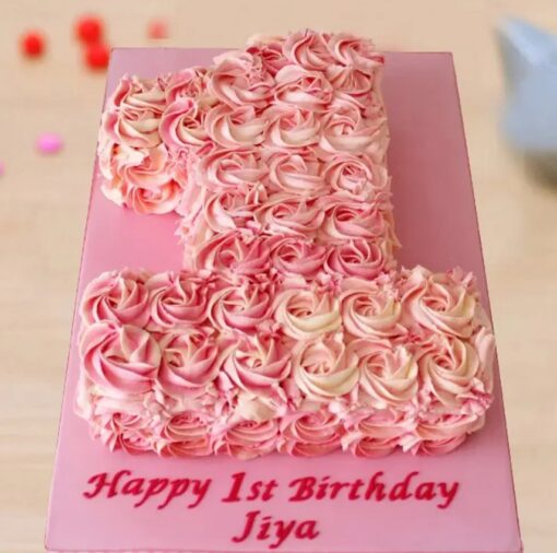 Number one-shaped cake decorated with blooming rose designs in soft hues, ideal for a first birthday or milestone celebration.