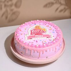 Sprinkled Barbie Cake adorned with vibrant sprinkles, Barbie-themed decorations, and pastel hues, perfect for a fun and colorful celebration.