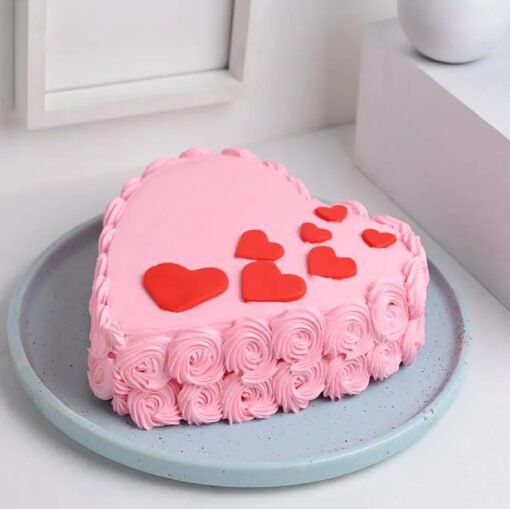 Heart-shaped cake adorned with fresh strawberries and rose frosting, ideal for romantic occasions like anniversaries or Valentine's Day.