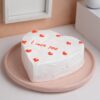 Heart-shaped Vanilla Valentine Cake with smooth frosting and delicate decorations, perfect for expressing love on Valentine's Day.