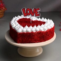 Heart-shaped red velvet cake with creamy frosting, ideal for anniversaries, Valentine's Day, or heartfelt celebrations.