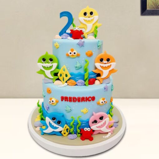 A colorful and playful Baby Shark Tier Cake featuring bright oceanic designs and playful shark toppers.