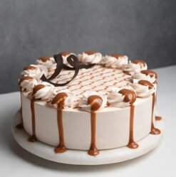 Caramel Bliss Drip Cake with moist sponge layers, caramel frosting, and an elegant caramel drip design.