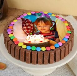 Cherished KitKat Photo Cake featuring a personalized photo topper, creamy layers, and surrounded by KitKat bars tied with a ribbon.