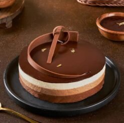 Triple Treat Mousse Cake featuring layers of chocolate, coffee, and fruit-infused mousse for a luxurious dessert experience.