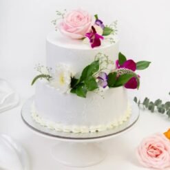 Elegant wedding cake adorned with delicate floral decorations, symbolizing love and beauty for a picture-perfect wedding celebration.