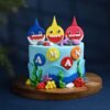 Baby Shark Cake with colorful ocean-themed decorations, featuring Baby Shark family toppers, waves, and edible sea creatures, perfect for kids' parties.