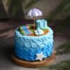 Beach Fun Cake with edible sand, ocean waves, palm trees, and beach-themed decorations, perfect for summer celebrations and tropical parties.
