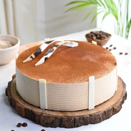 Delicious Coffee Vanilla Cake with moist vanilla sponge, infused with rich coffee flavor, layered with creamy frosting, and topped with chocolate drizzle.