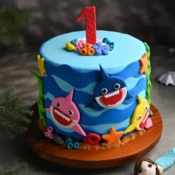 Dancing Baby Sharks Cake with colorful fondant baby sharks, ocean waves, and musical notes, perfect for a fun-filled birthday party.