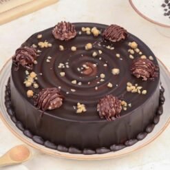 Elegant Ferrero Truffle Cake with rich chocolate layers, smooth hazelnut filling, and Ferrero Rocher toppings for a decadent dessert experience.