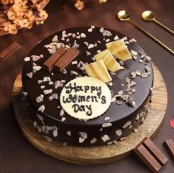 Graceful KitKat Women's Day Cake – a decadent chocolate cake wrapped in KitKat bars and adorned with elegant decorations for Women's Day.